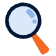 Ikona przedstawiająca powiększoną lupę z niebieską soczewką i pomarańczową rączką, symbolizującą wyszukiwanie lub eksplorację.