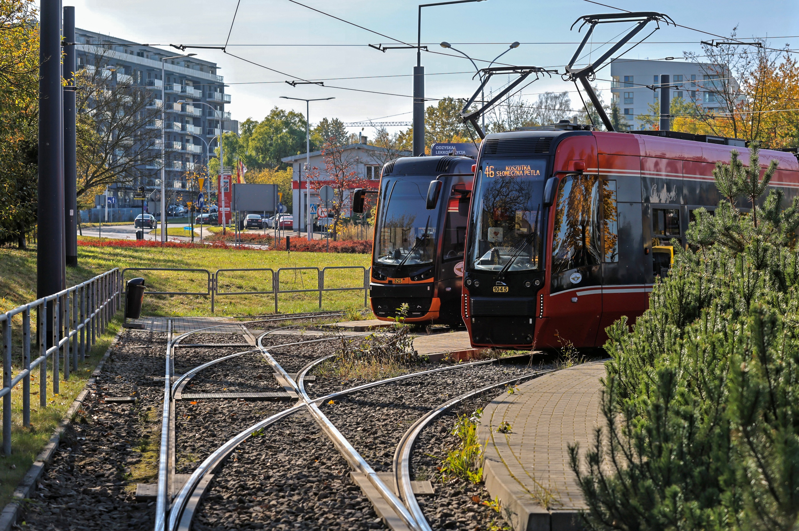 Dwa nadjeżdżające czerwone tramwaje